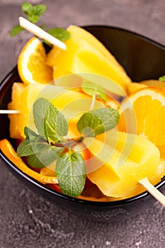 Homemade orange popsicle with ripe orange and fresh mint