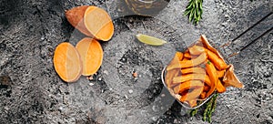 Homemade Orange Sweet Potato Fries with lime and herbs, Long banner format. top view