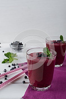 Homemade organic blueberry smoothy with berries and mint leaf.