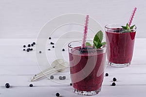 Homemade organic blueberry smoothy with berries and mint leaf.