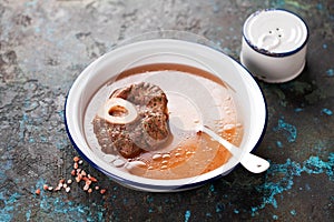 Homemade organic bone Broth soup with Meat and spice in a white bowl