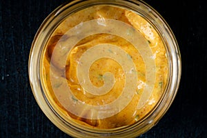 Homemade organic Dijon mustard on a dark wooden background, souce for meat dishes