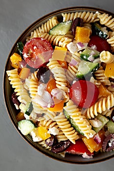 Homemade Organic Greek Pasta Salad in a Bowl, top view. Flat lay, overhead, from above
