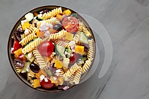 Homemade Organic Greek Pasta Salad in a Bowl, top view. Flat lay, overhead, from above. Copy space