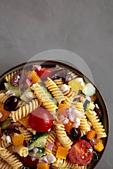 Homemade Organic Greek Pasta Salad in a Bowl, top view. Flat lay, overhead, from above. Copy space