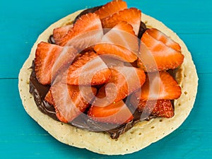 Homemade Pancake With Fresh Sliced Strawberries and Chocolate Spread