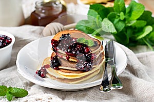 Homemade pancakes with berry sauce coulis and mint photo