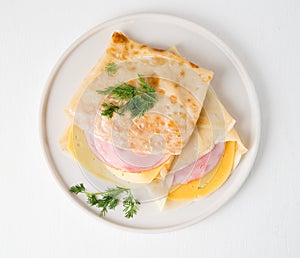 Homemade pancakes with ham and cheese on a white background, Maslenitsa