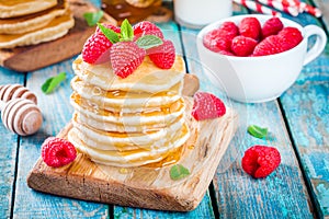 Homemade pancakes with honey and raspberry