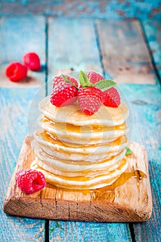 Homemade pancakes with honey and raspberry