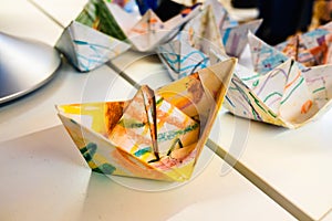 Homemade paper boats decorated with colors for children a day of crafts photo