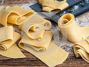 Homemade pappardelle pasta in making photo