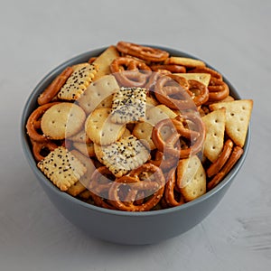 Homemade Party Snack Mix with Crackers and Pretzels in a Bowl, side view. Close-up