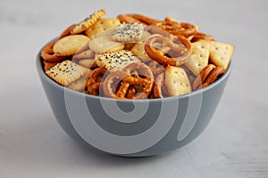 Homemade Party Snack Mix with Crackers and Pretzels in a Bowl, side view. Close-up