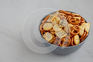 Homemade Party Snack Mix with Crackers and Pretzels in a Bowl, side view. Copy space