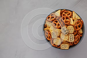 Homemade Party Snack Mix with Crackers and Pretzels in a Bowl, top view. Flat lay, overhead, from above