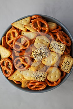 Homemade Party Snack Mix with Crackers and Pretzels in a Bowl, top view. Flat lay, overhead, from above. Close-up