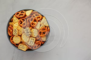 Homemade Party Snack Mix with Crackers and Pretzels in a Bowl, top view. Flat lay, overhead, from above. Copy space