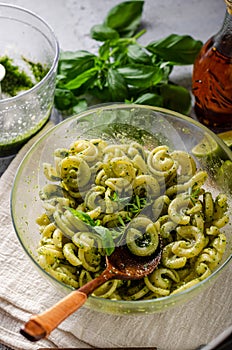 Homemade pasta with fresh basil pesto and tomatoes