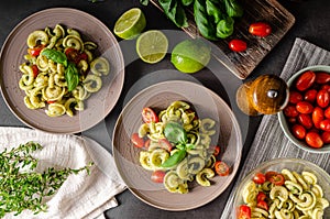 Homemade pasta with fresh basil pesto and tomatoes