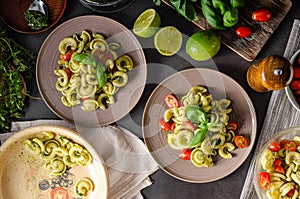 Homemade pasta with fresh basil pesto and tomatoes