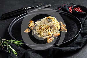 Homemade Pasta Spaghetti with mussels, tomato sauce on black background. sea food meal