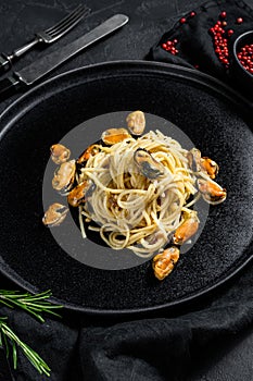 Homemade Pasta Spaghetti with  mussels, tomato sauce on black background. sea food meal