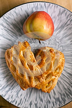 Homemade pastries freshly baked puff pastry puffs with apples on a plate close-up