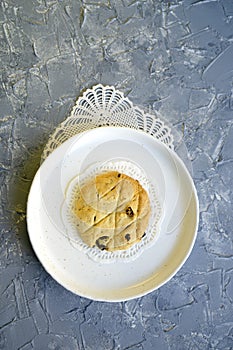 Homemade pastries with raisins on a white plate