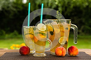 Homemade peach ice tea with lime and lemon balm