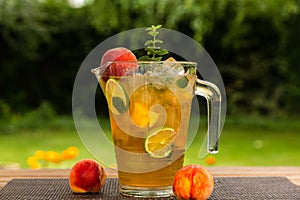 Homemade peach ice tea with lime and lemon balm