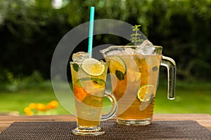 Homemade peach ice tea with lime and lemon balm