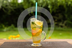 Homemade peach ice tea with lime and lemon balm