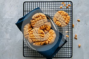 Homemade peanut butter cookies on a wire rack. Gray background.