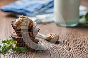 Homemade peanut butter cup, stack of dark chocolate with milk bottle, dessert food