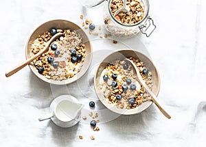 Homemade peanut butter granola with greek yogurt and blueberries on a light background, top view. Healthy energy breakfast or snac