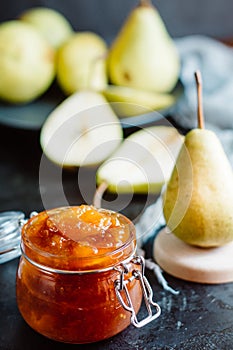 Homemade pear jam on dark background on background fresh ripe pears