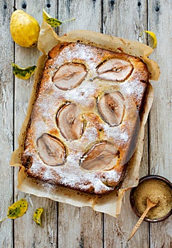 Homemade pears cake on natural wooden background