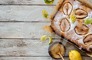 Homemade pears cake on natural wooden background