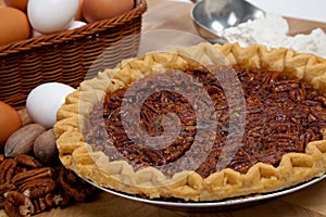 Homemade pecan pie with ingredients