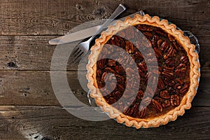 Homemade pecan pie, top view over wood