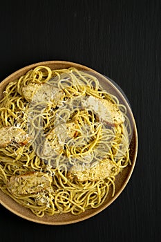 Homemade Pesto alla Genovese Pasta on a Plate on a black background, top view. Flat lay, overhead, from above