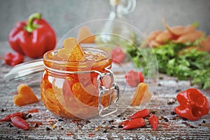 Homemade pickled carrots with garlic and chili in glass jars