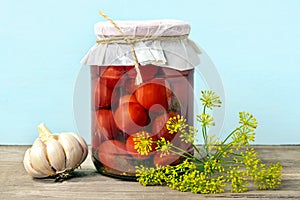 Homemade pickled cherry tomatoes, cucumbers, champignons, garlic, eggplant, red peppers in jars on wooden shelf Homemade canned