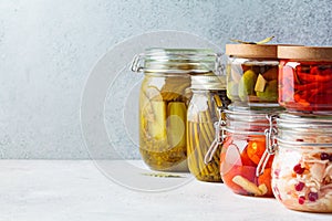 Homemade pickled and fermented vegetables in glass jars, copy space. Home preservation concept