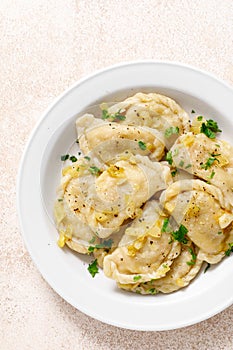 Homemade pierogi, dumplings, varenyky or vareniki with cabbage