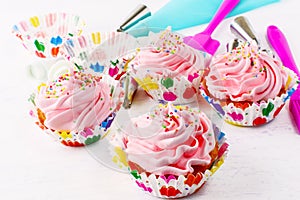 Homemade pink birthday cupcakes and cookware