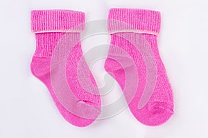 Homemade pink wool socks for baby.