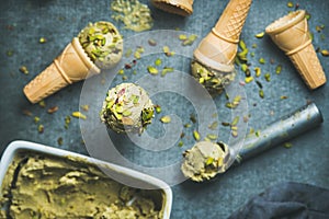 Homemade pistachio ice cream in ceramic mold and metal scooper