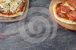 Homemade pizza detail on wooden background